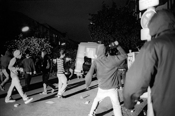 Demonstrators assault a police bus. Image: Michel Meijer