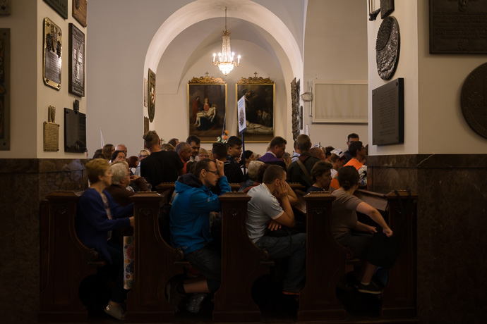 Pilgrims wait and pray in the chapel where the painting of the Black Madonna hangs. Image: Michel Meijer