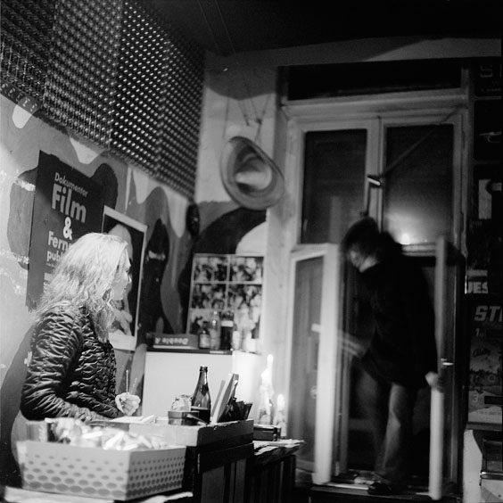 Desk with staff member in the reception area of the cinema. Image: Michel Meijer