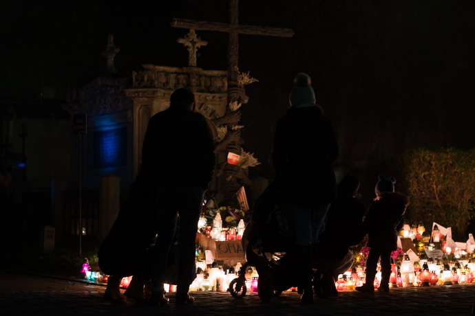 A family stands in front of the monument honouring the victims of the communist regime in Poland, All Saints' Day in Poland Image: Michel Meijer