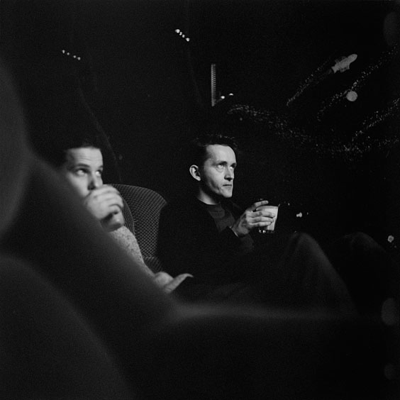 Two staff members drink a cocktail while watching a film. Image: Michel Meijer