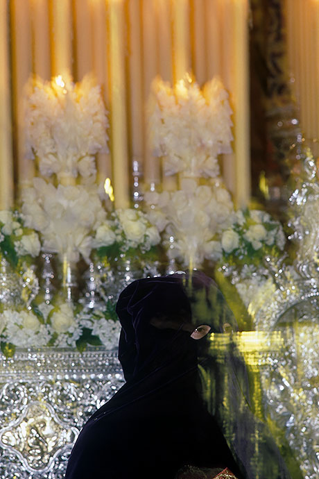 A penitent stands before one of the altars. Image: Michel Meijer
